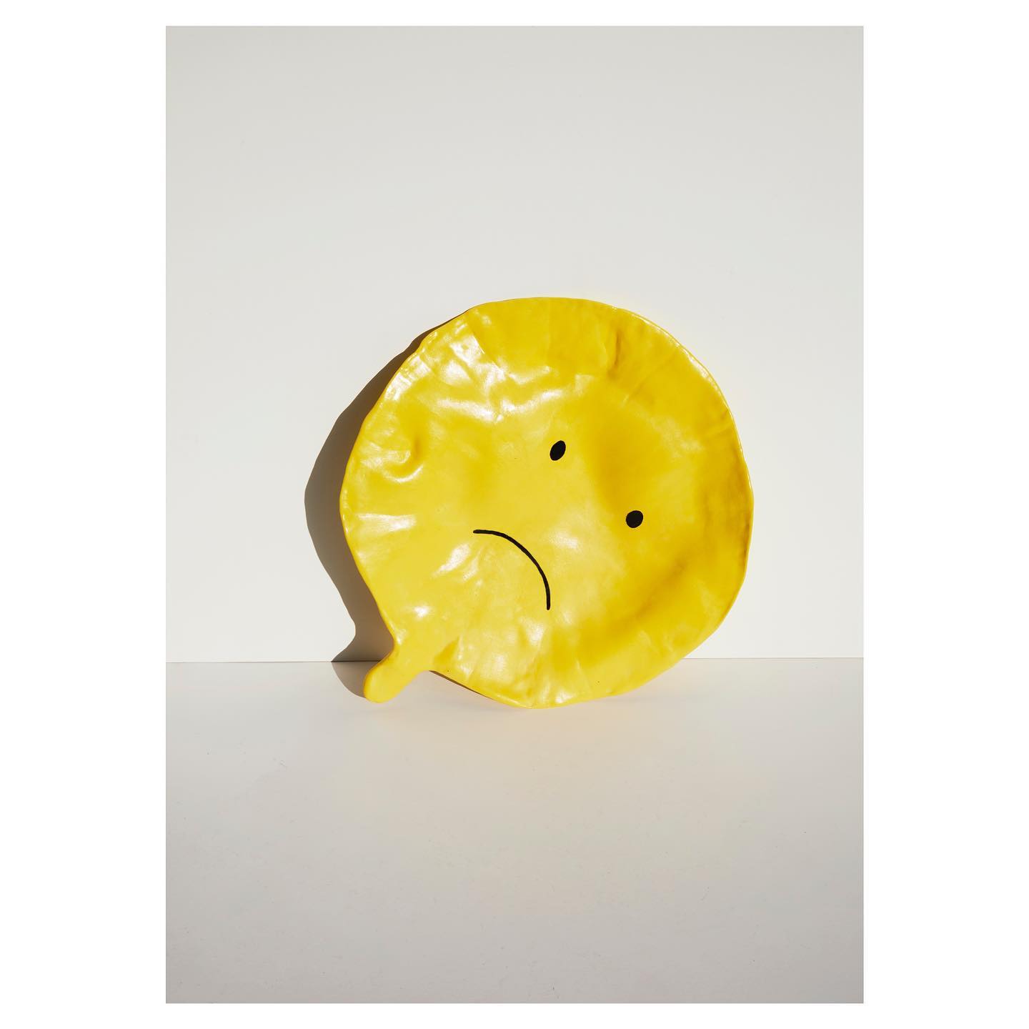 Deflated balloon, yellow — view 1